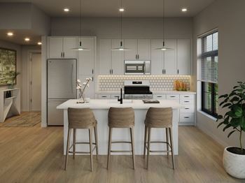 A modern kitchen with a white island and bar stools.